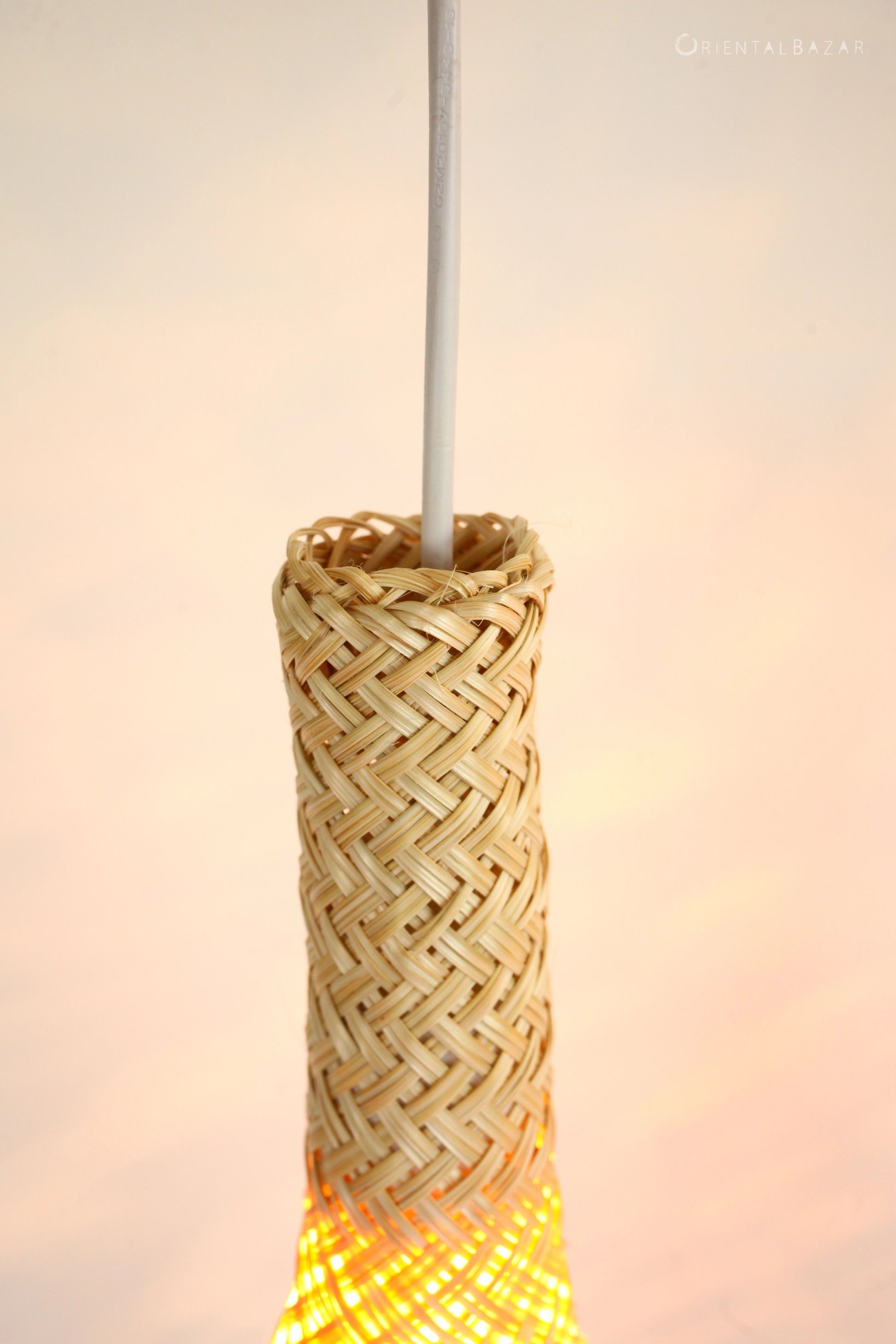 Woven bamboo straw lantern with a blurred background