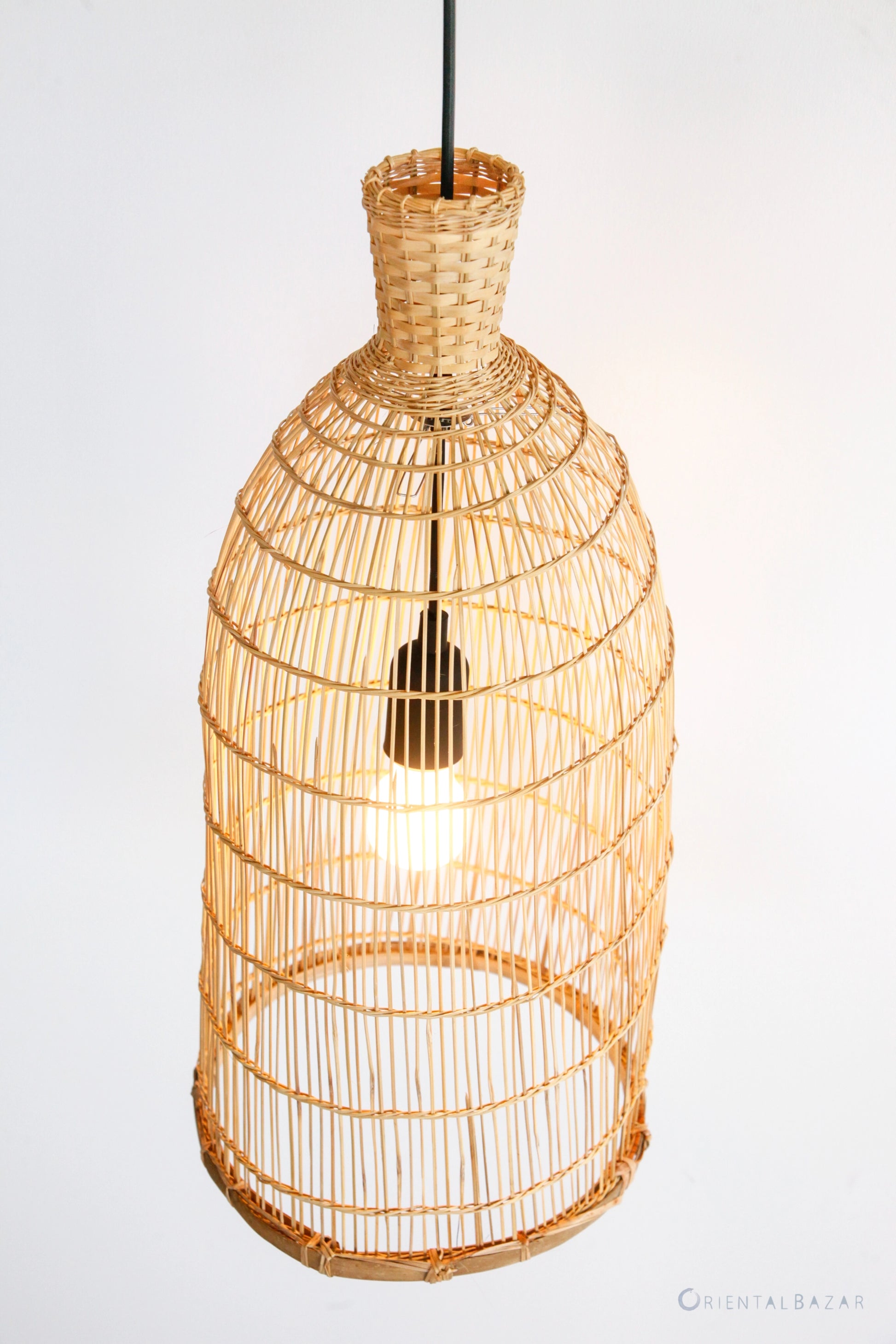 Woven bamboo pendant light on a white background