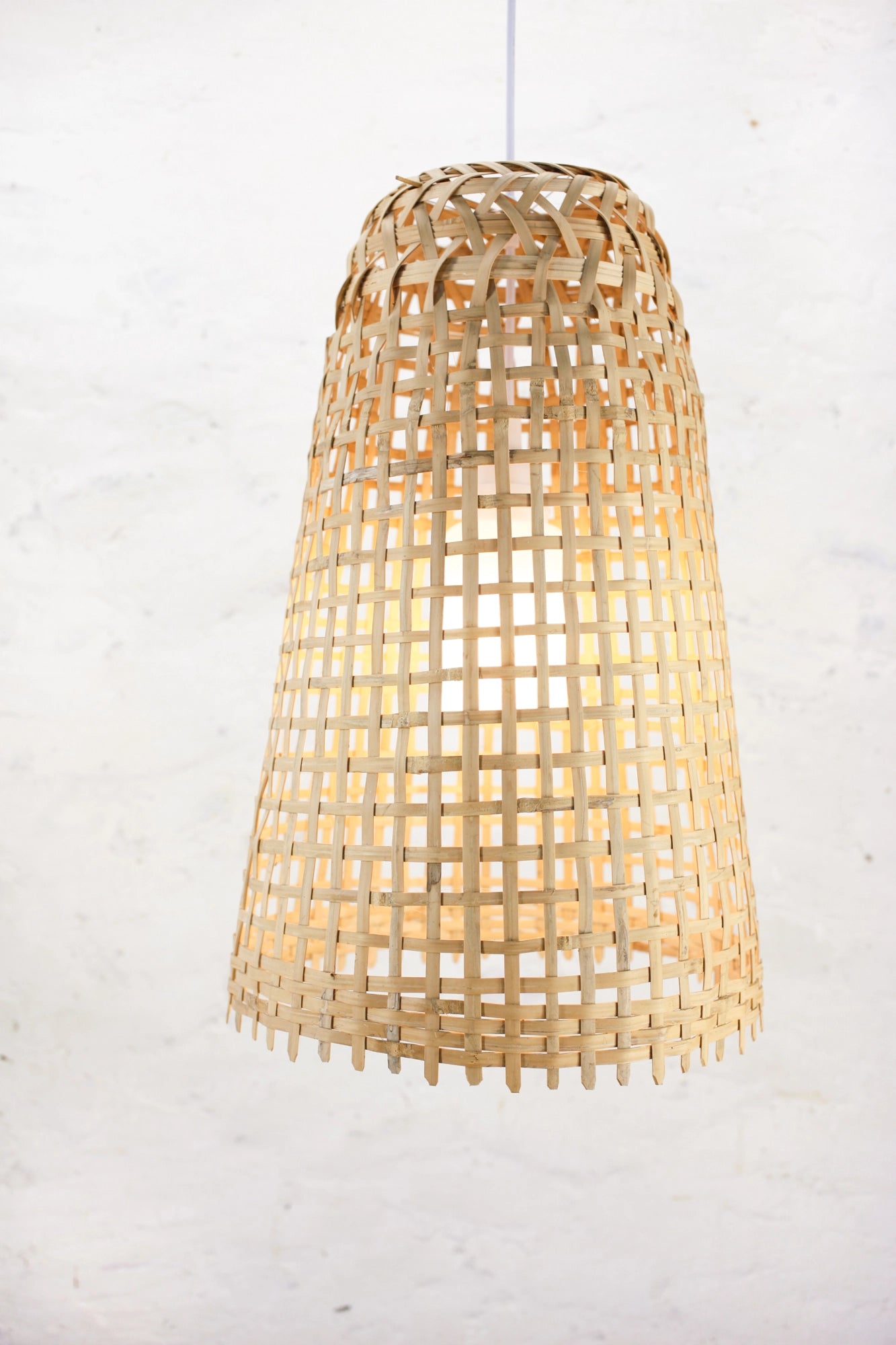 Fish-trap woven bamboo pendant light on a white background