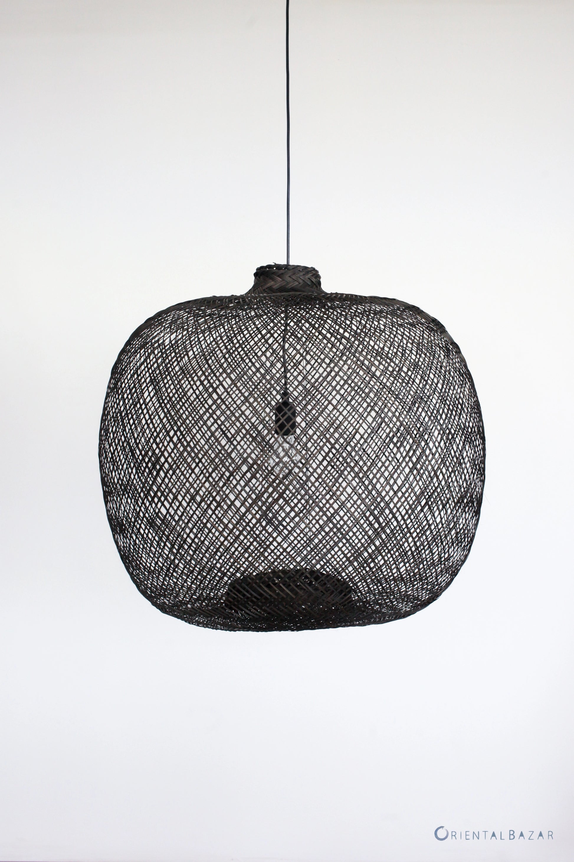 Black woven bamboo pendant light on a white background