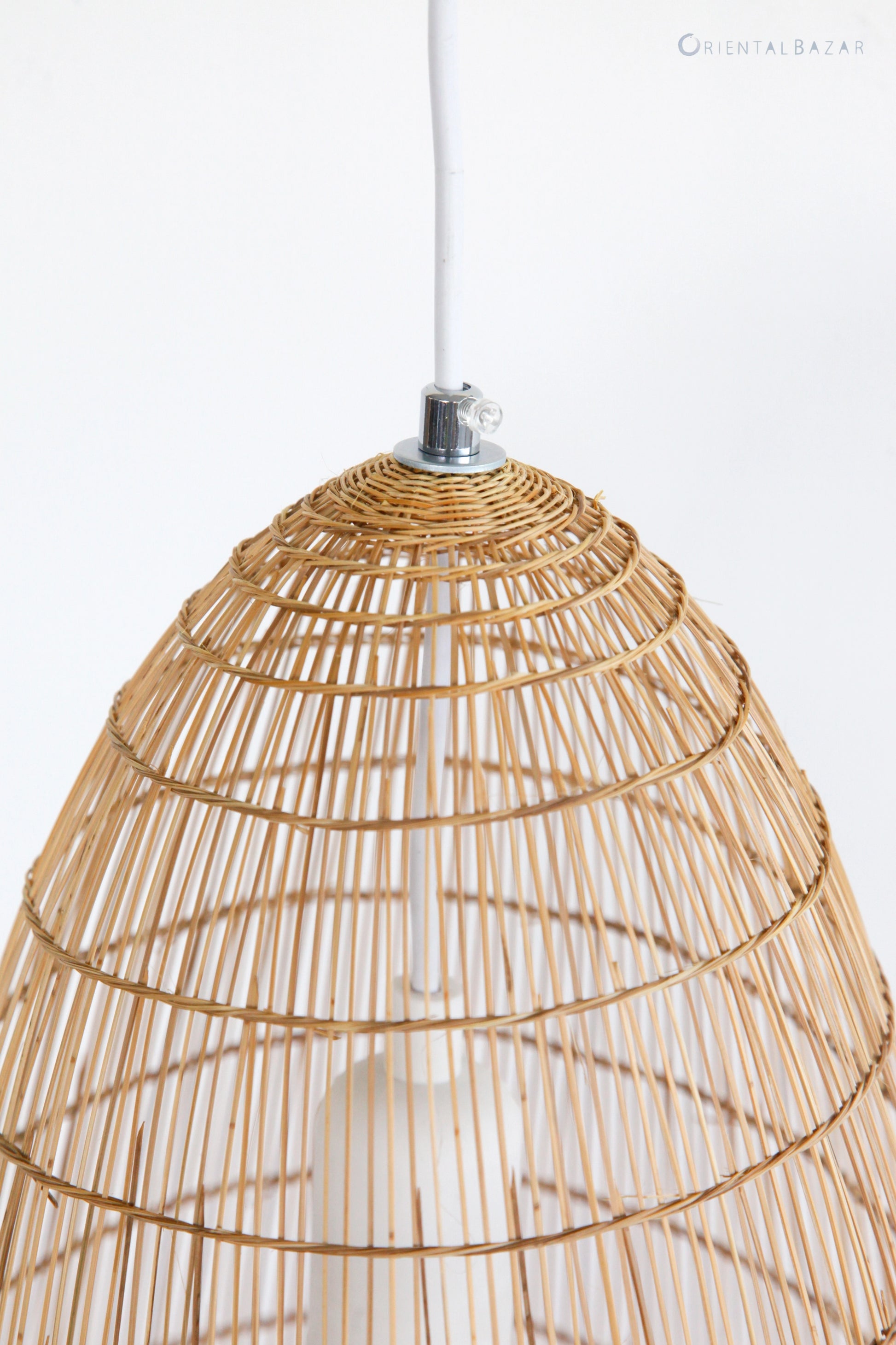 Closeup of the top part of woven bamboo pendant light on a white background