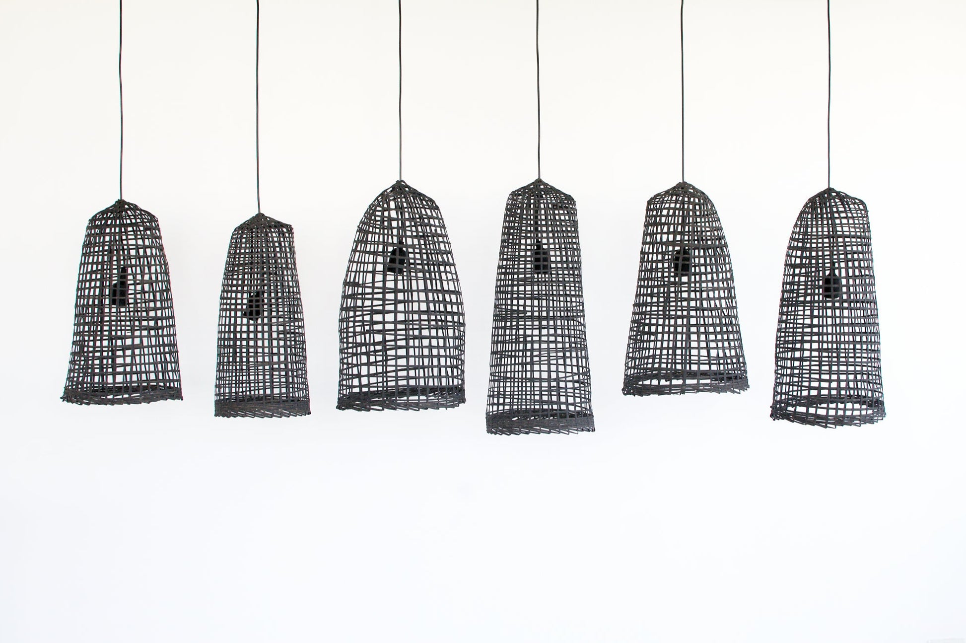 Set of six black wabi-sabi bamboo pendant lights on a white background