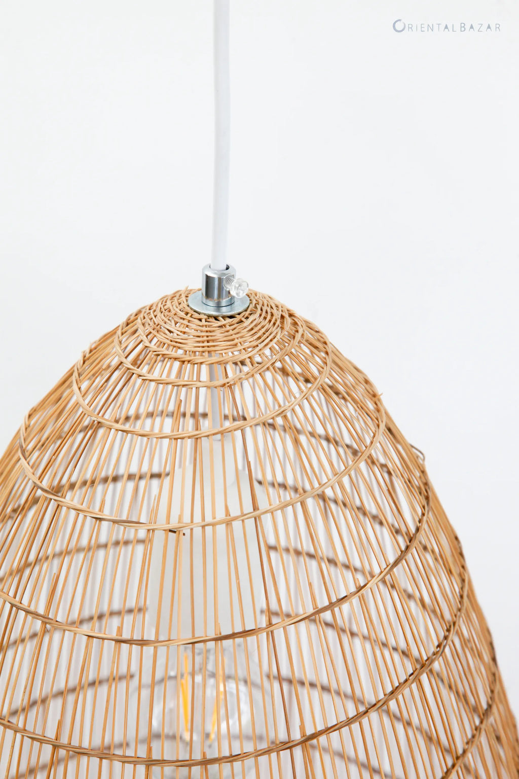 Closeup of the top part of a bamboo fish-trap lamp showing the metal fitter where the electric cord attaches to the shade. The background is white