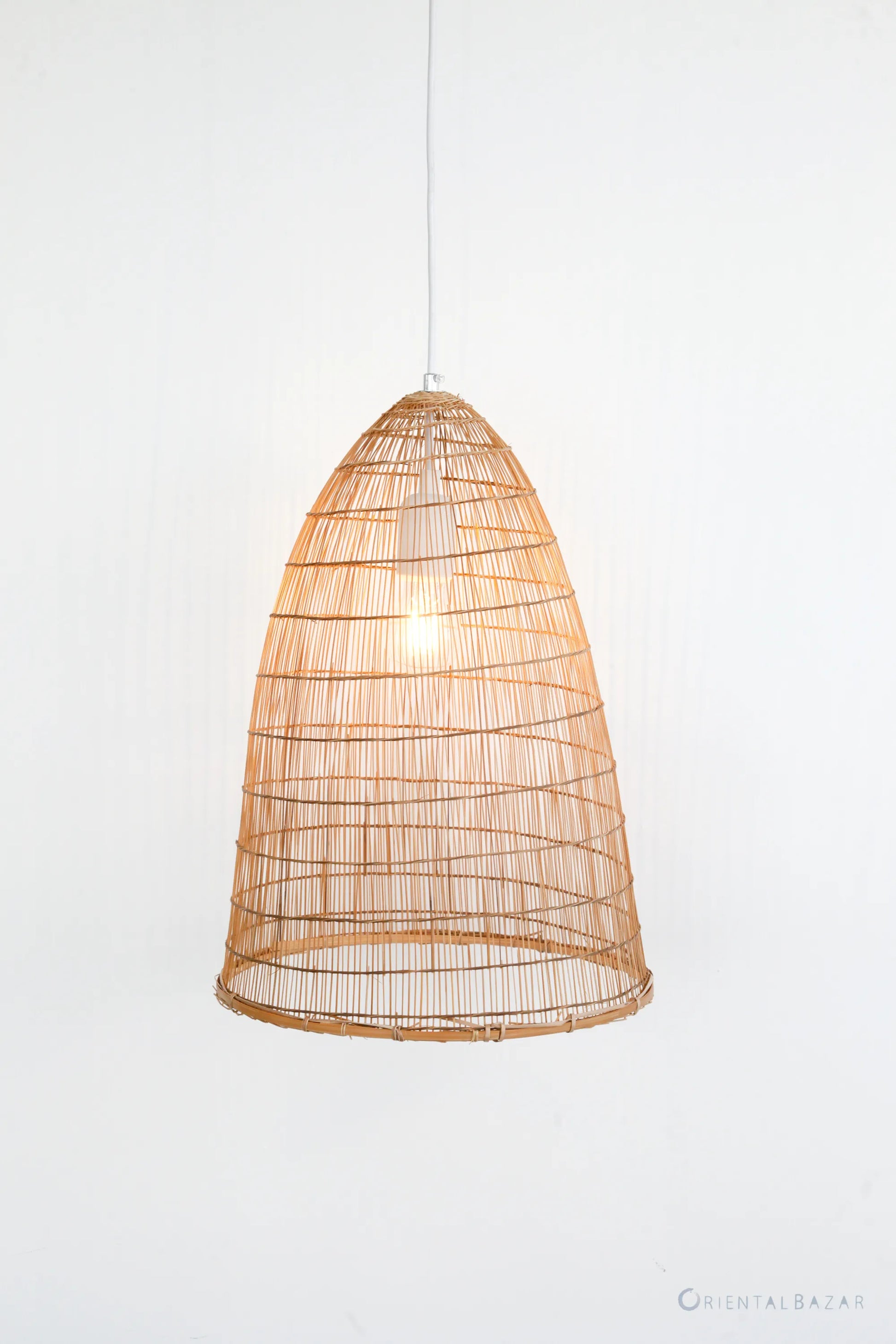 Woven bamboo pendant light on a white background