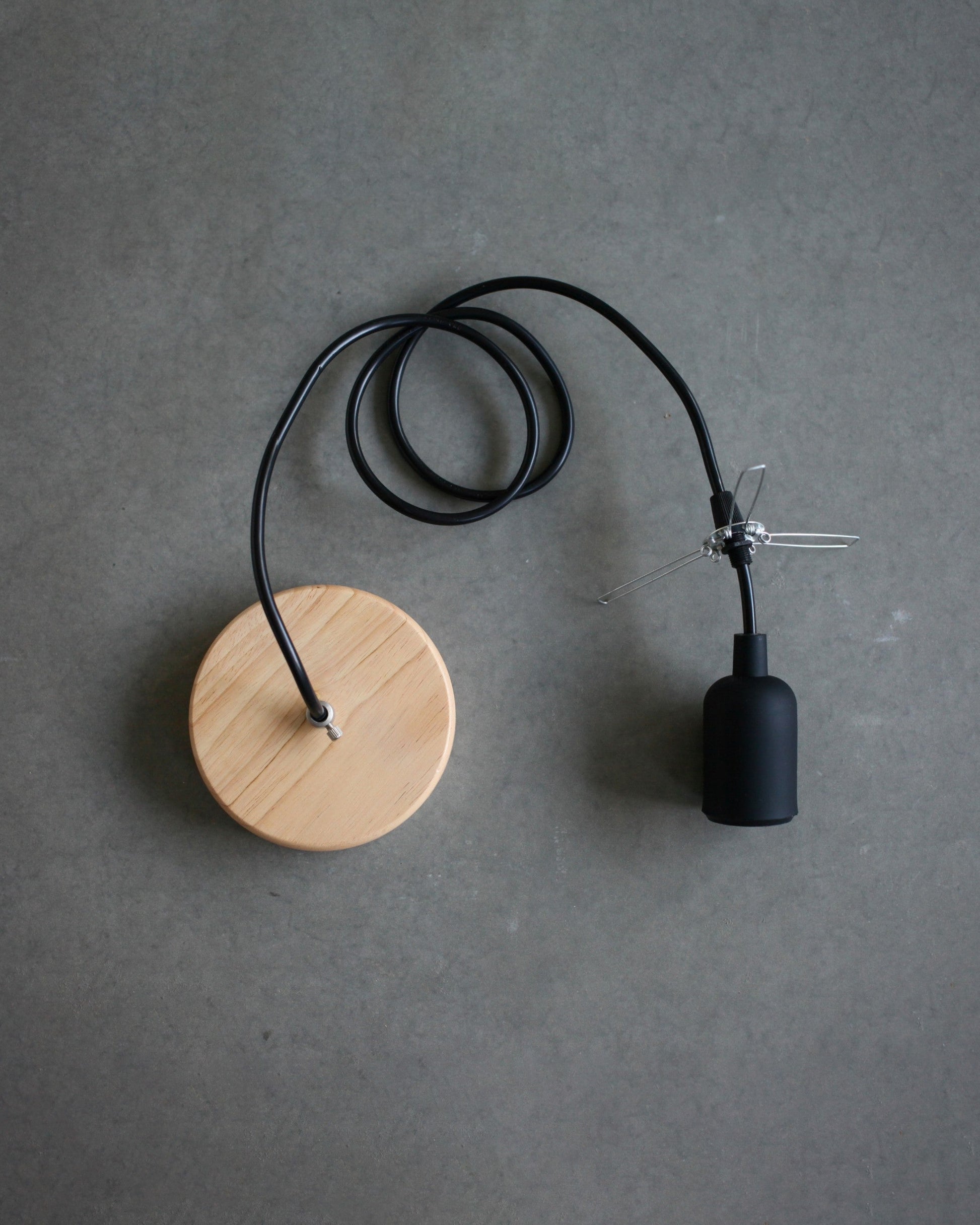 Pendant Lamp set with wooden canopy, black socket and cord with a lampshade holder on a gray background