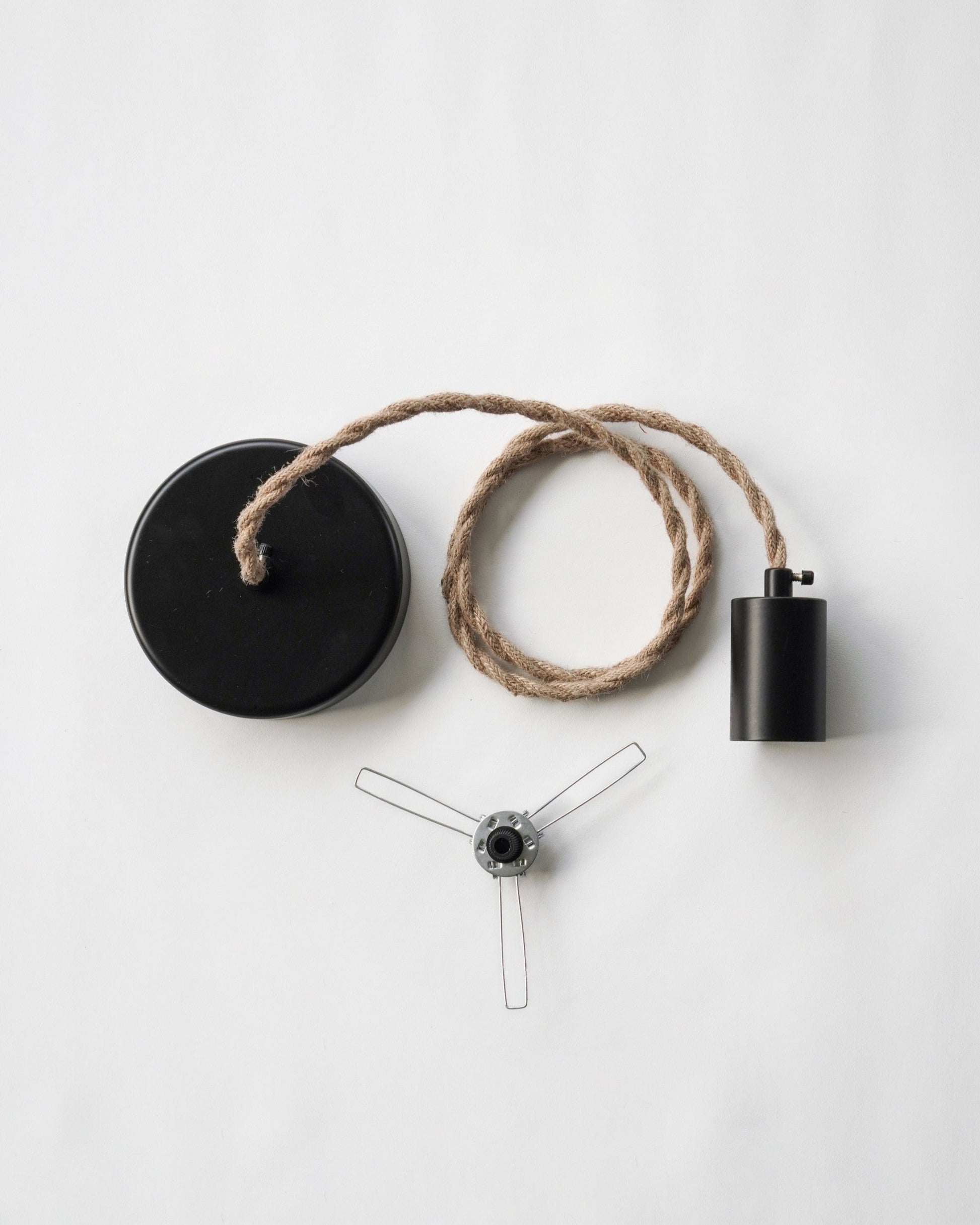 Pendant lamp with jute natural cord, black canopy and socket and a lampshade holder on a white background