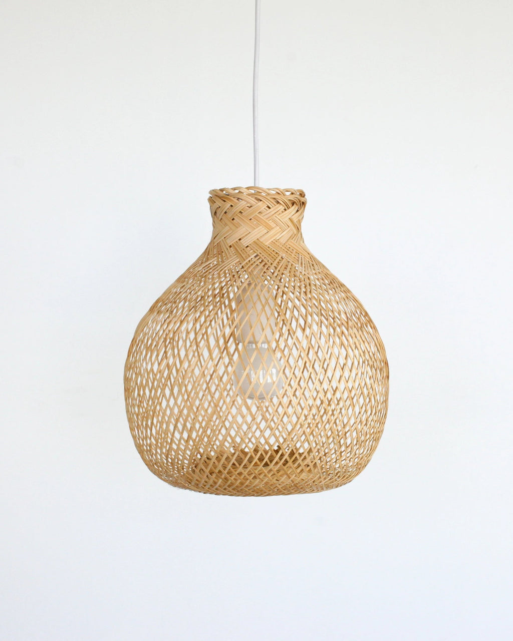 Boho woven bamboo pendant light on a white background