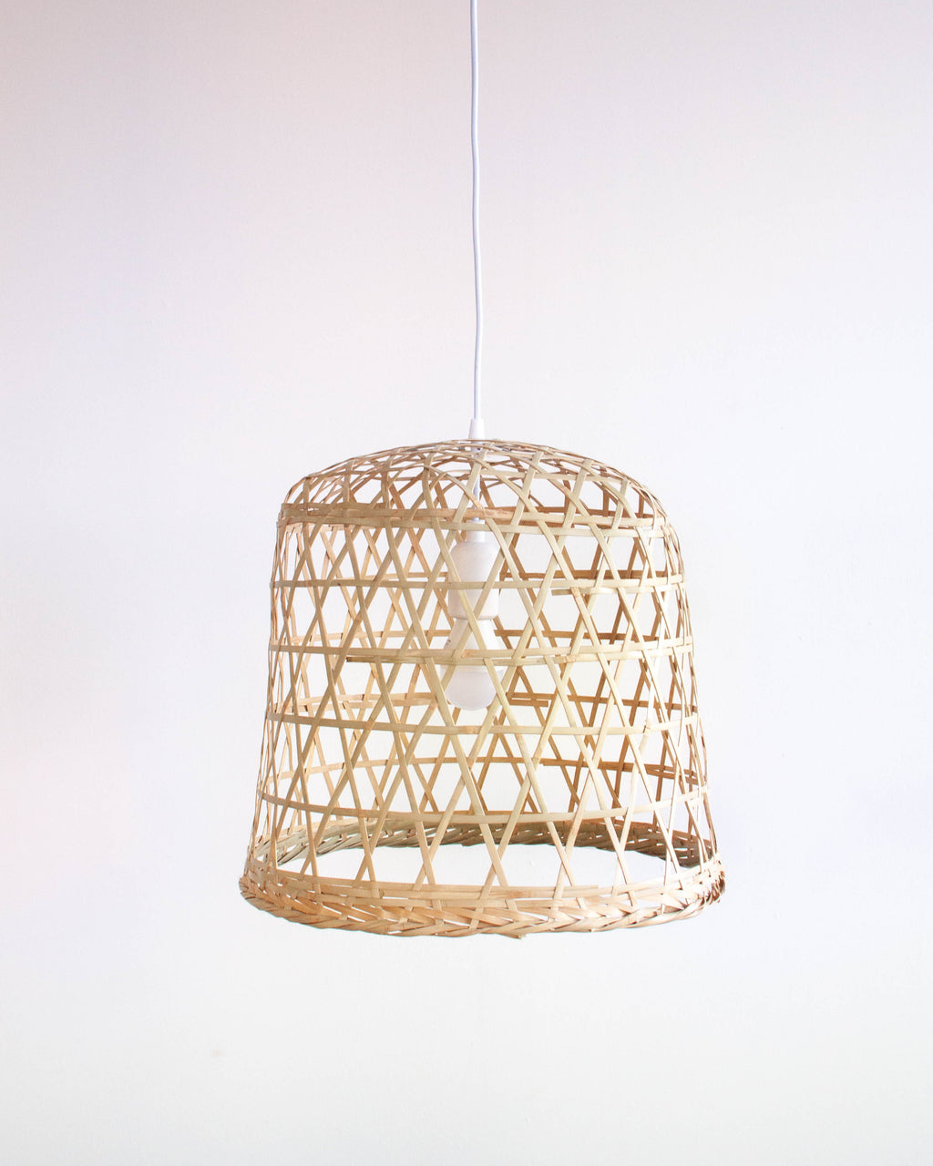 Woven bamboo basket lamp on a white background