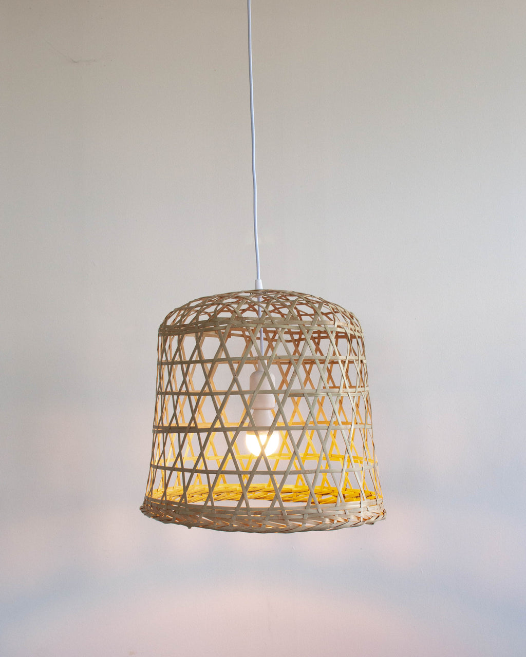 Woven bamboo basket lamp on a white background