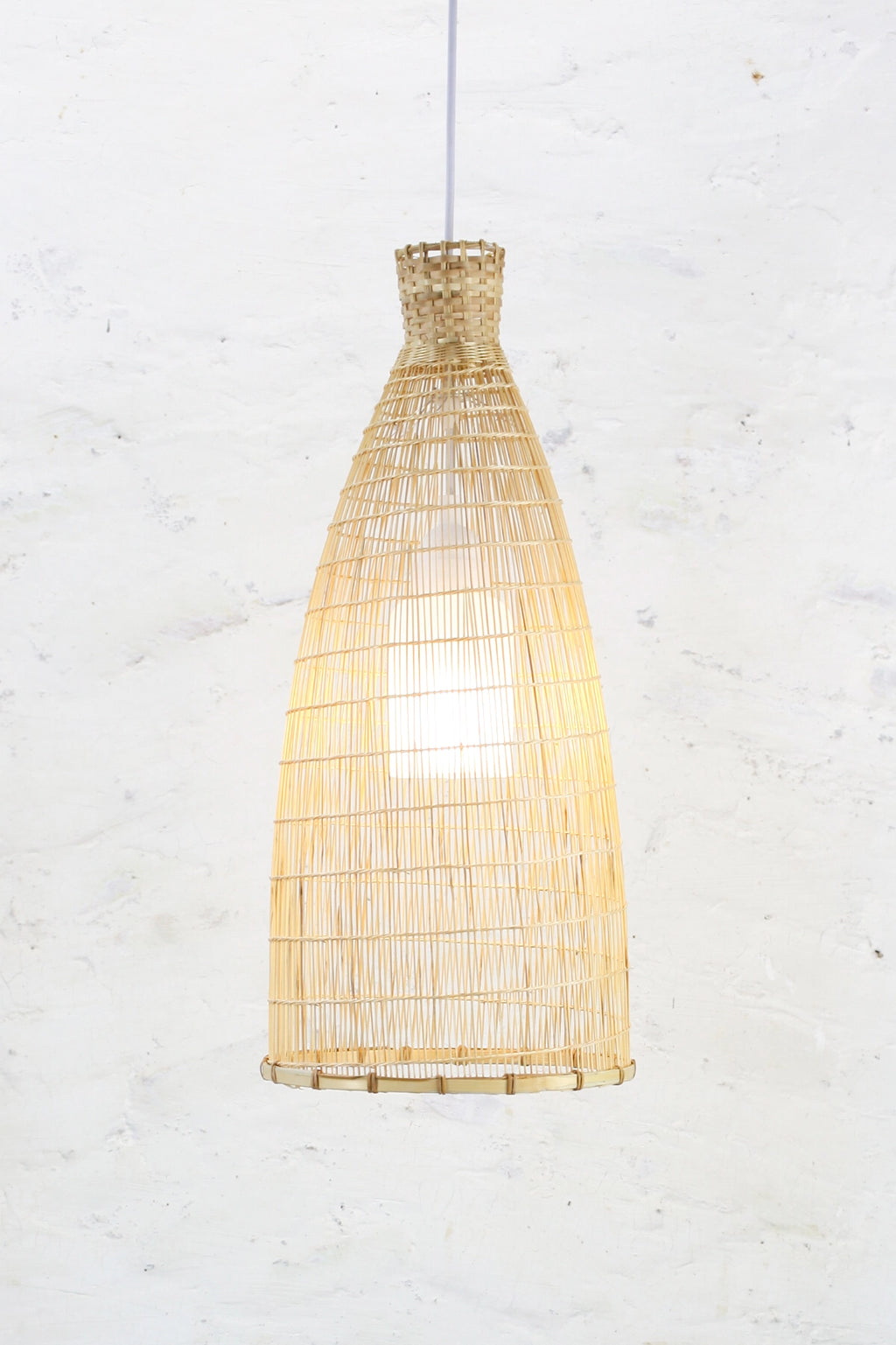 Boho Bamboo and rattan pendant light against a white textured wall