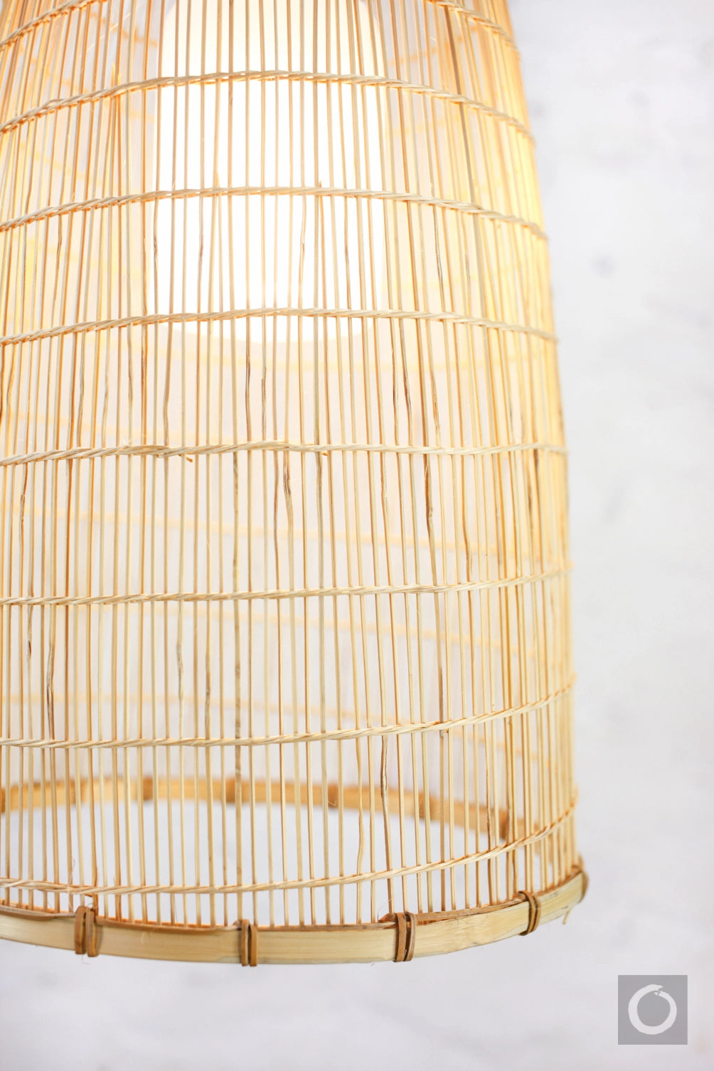 Close-up of a bamboo and rattan lampshade on a white background