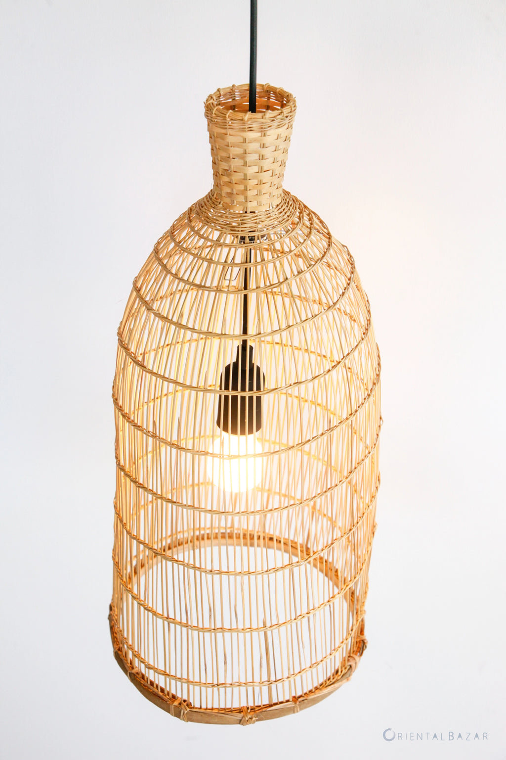 Woven bamboo pendant light on a white background