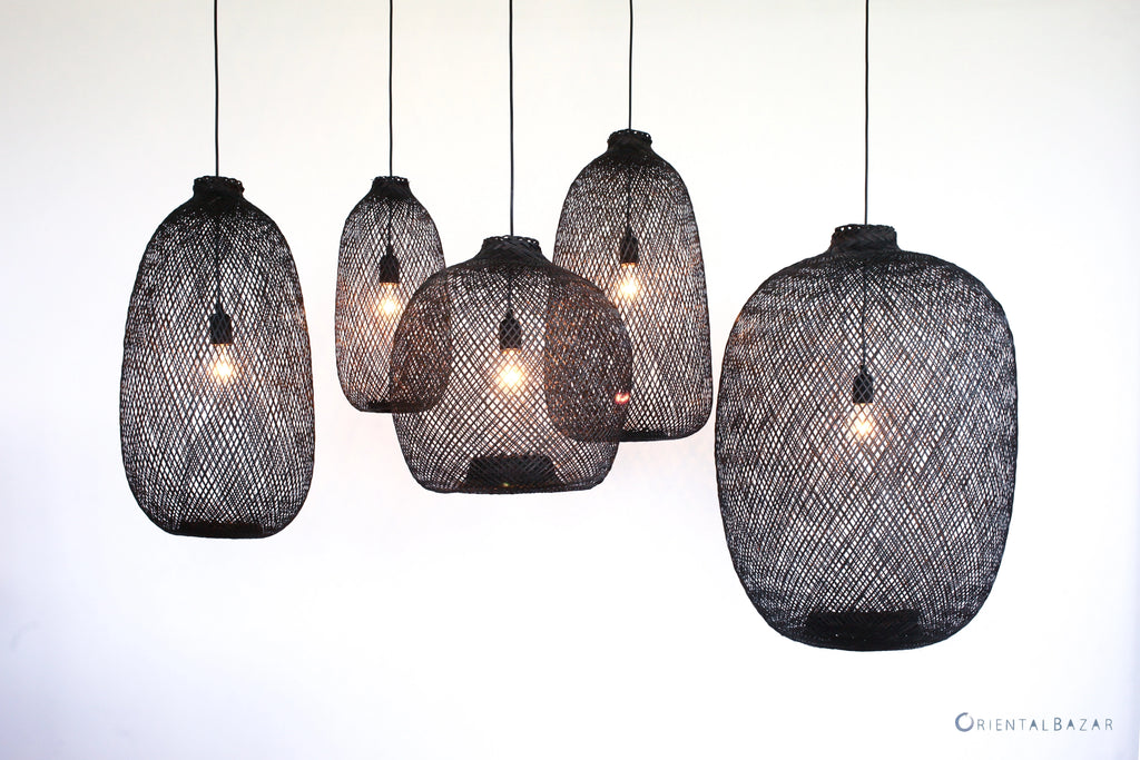 Set of black woven bamboo pendant lights on a white background