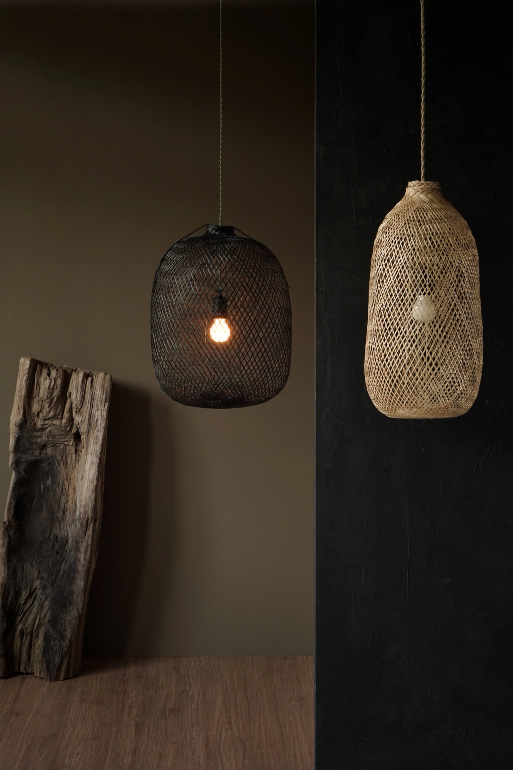 Two bamboo hanging lamps, one black and one natural color, against a dark background.
