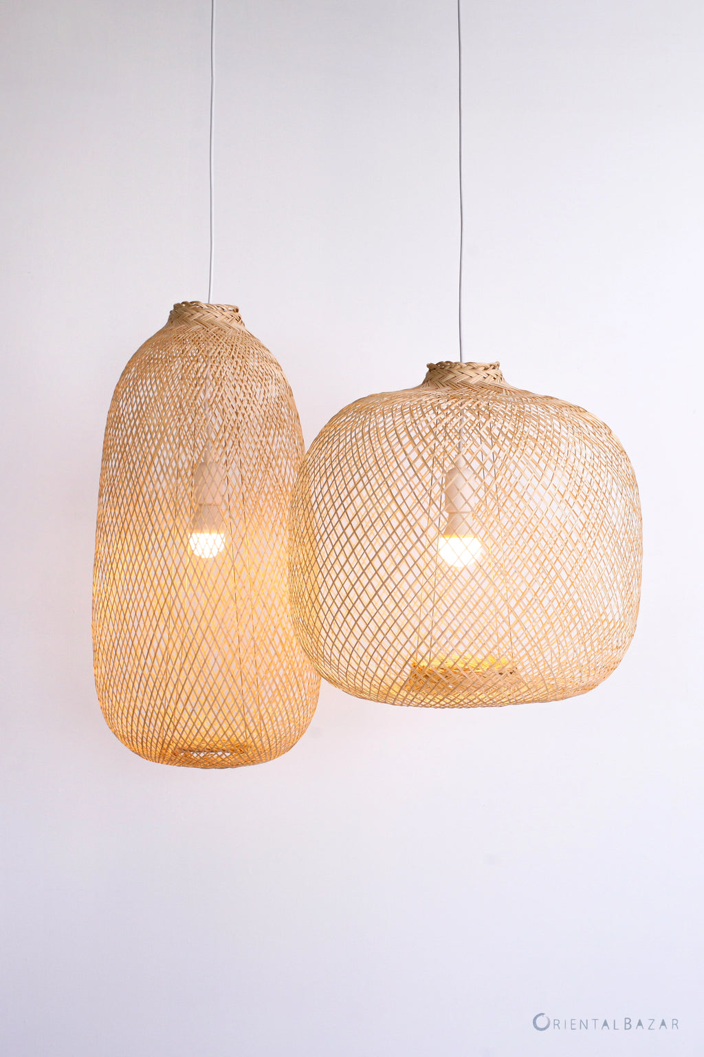 Two woven pendant lights hanging against a white background