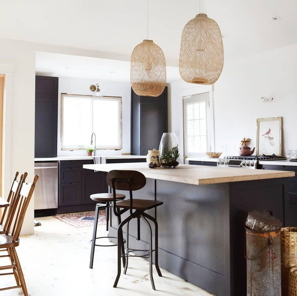 Minimalist kitchen setting with two woven bamboo hanging lamps over the kitchen island