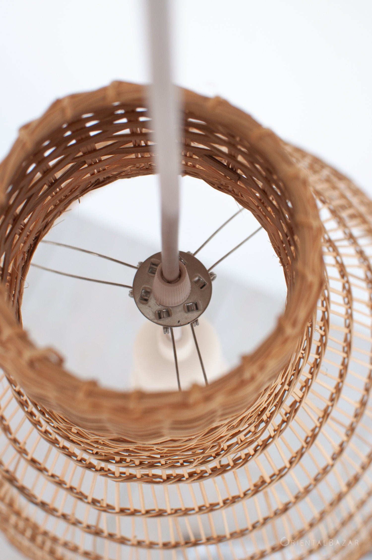 Metal bracket lampshade holder attached to a bamboo pendant light