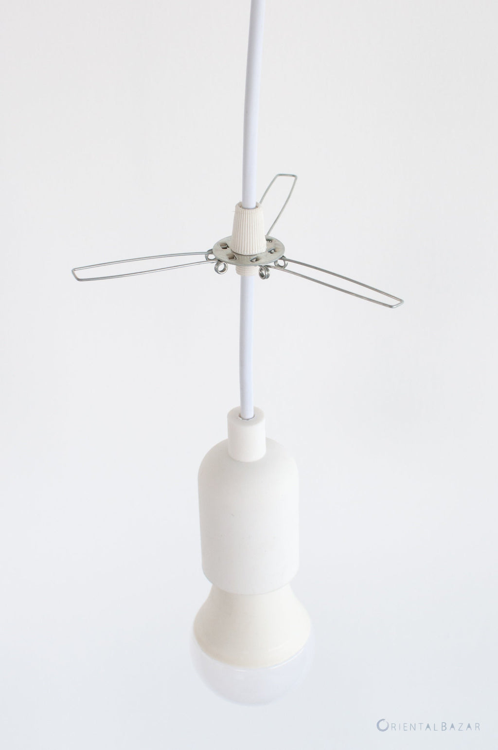 Lampshade holder fitter metal bracket attached to a white pendant light cord with white plastic grips