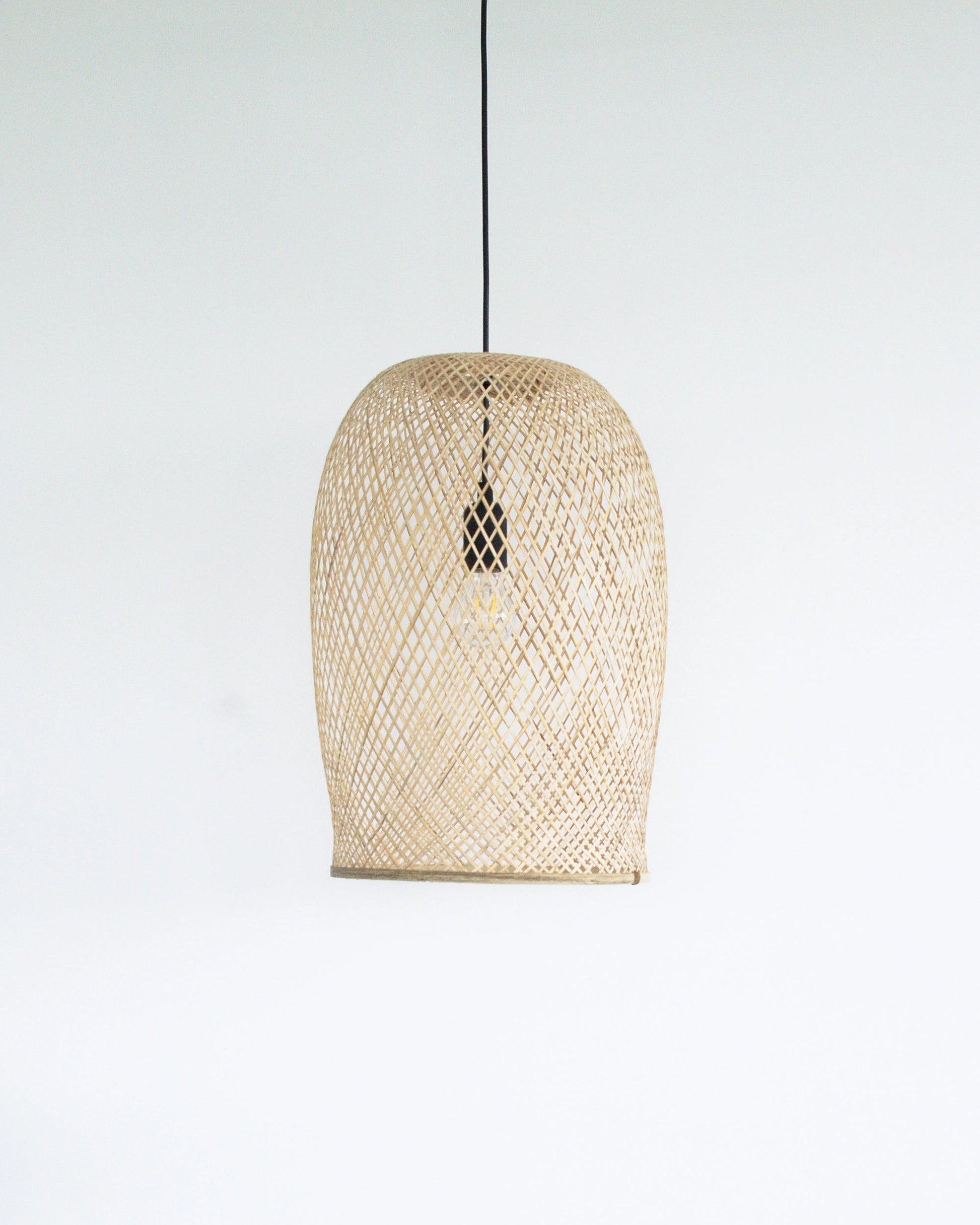 Woven bamboo pendant light on a white background
