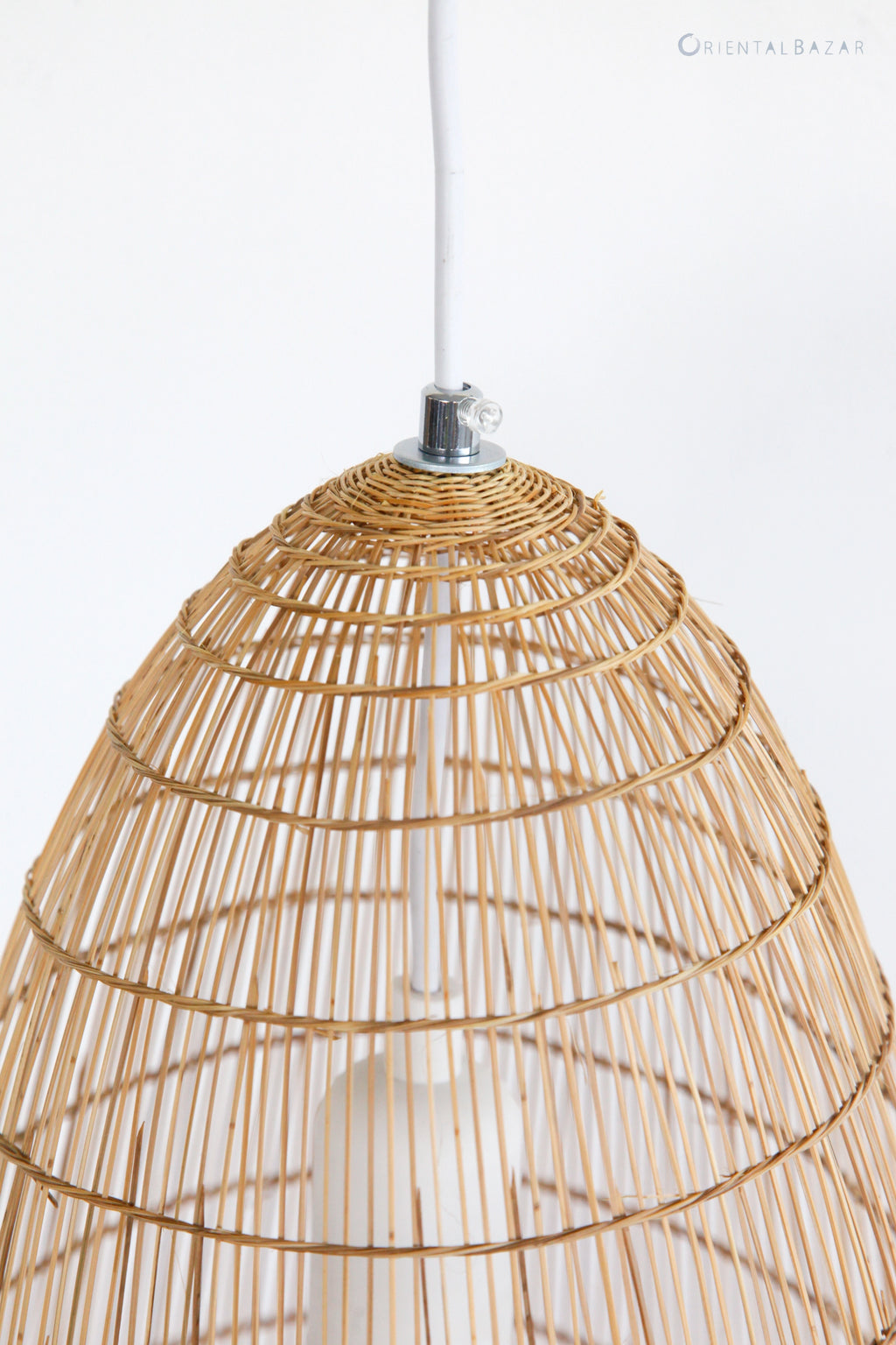 Closeup of the top part of woven bamboo pendant light on a white background