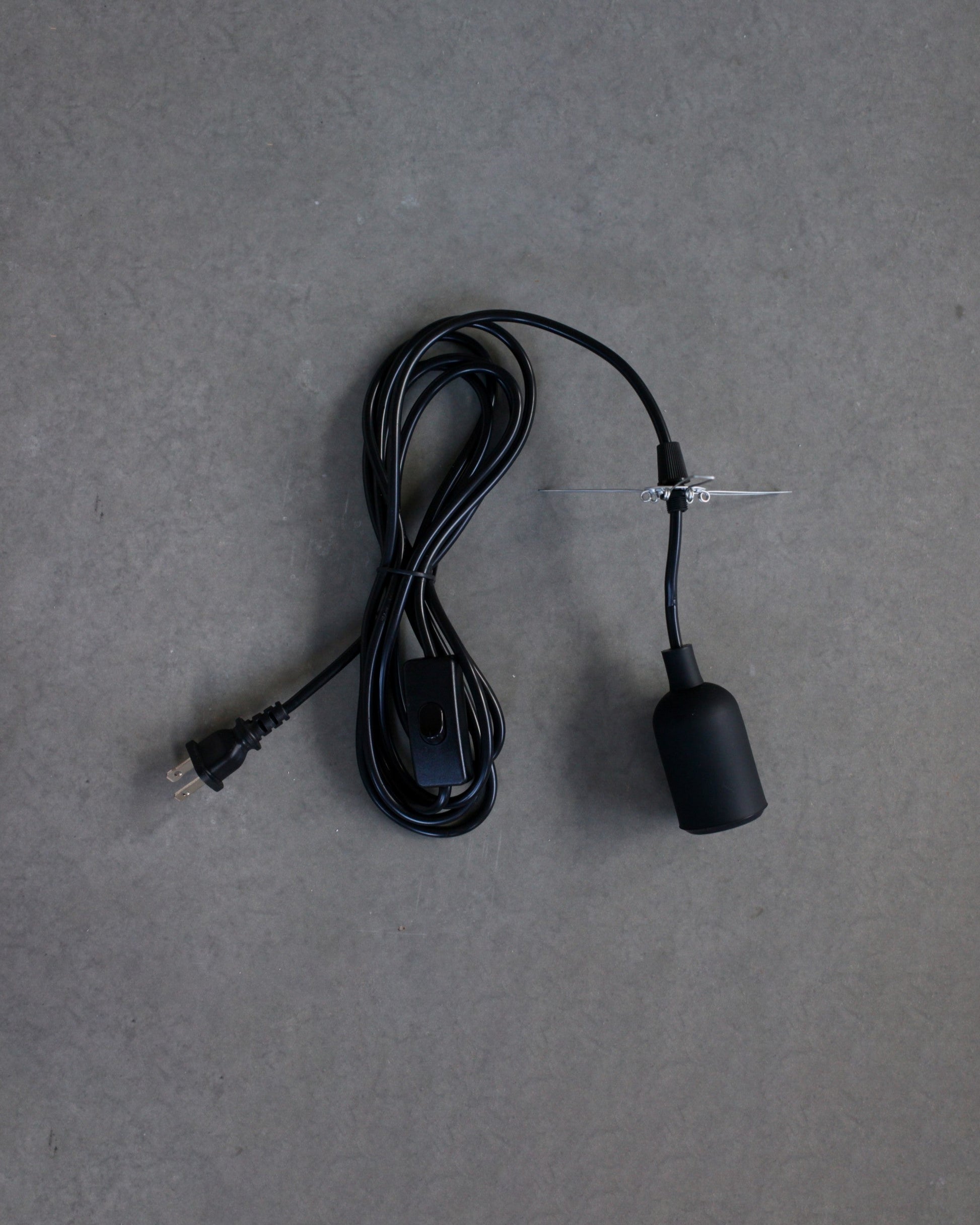 Black plug-in lamp set on gray background