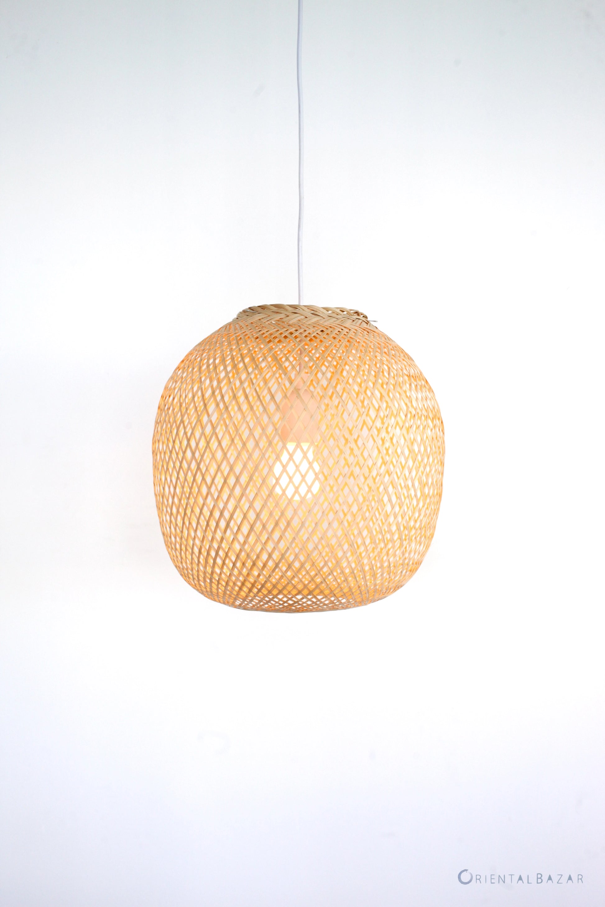 Round woven bamboo pendant light on a white background