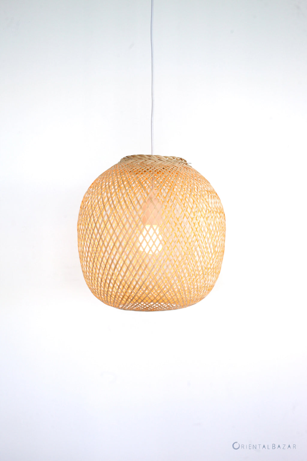 Round woven bamboo pendant light on a white background