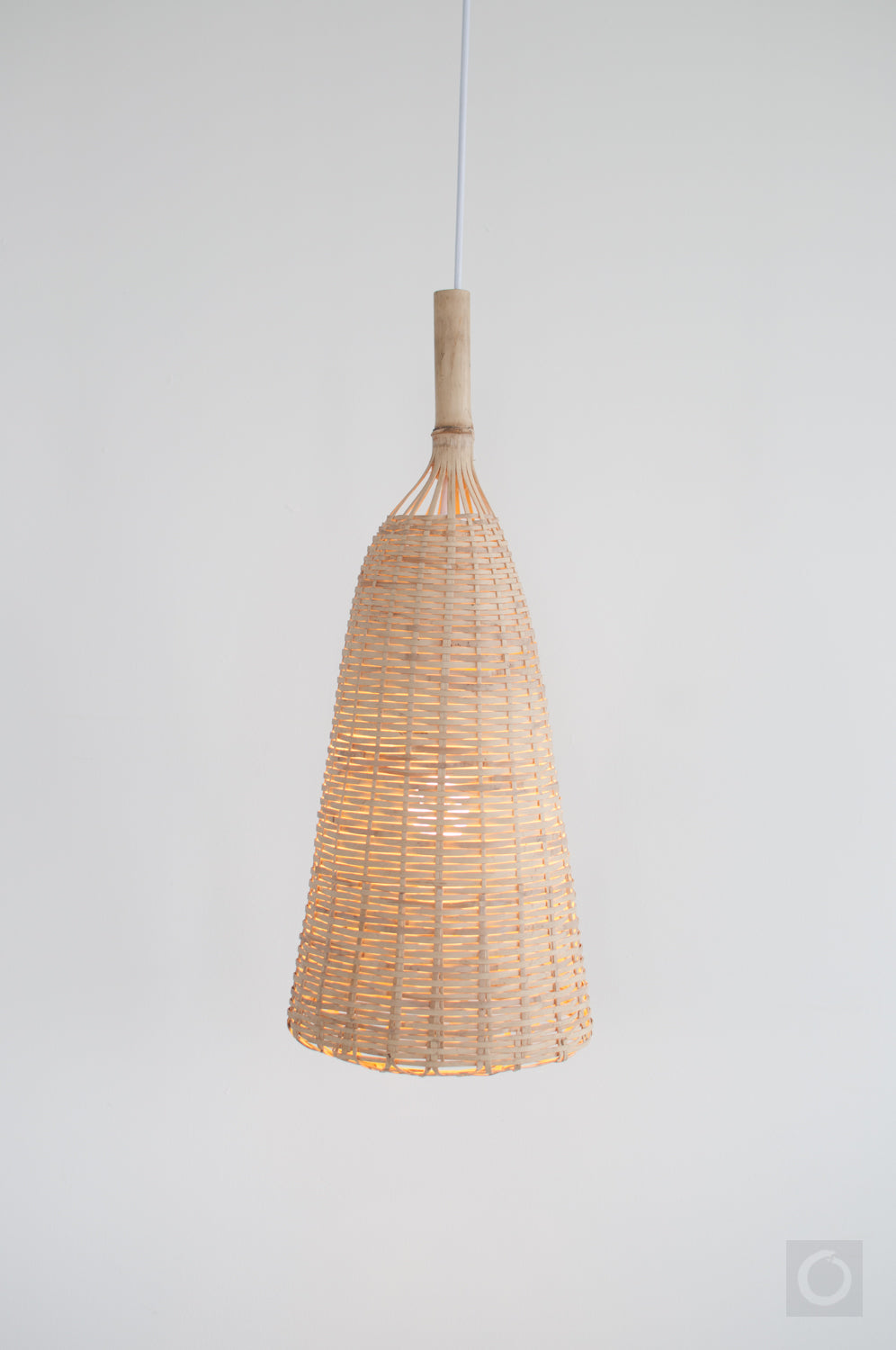 Rustic woven bamboo pendant light on a white background