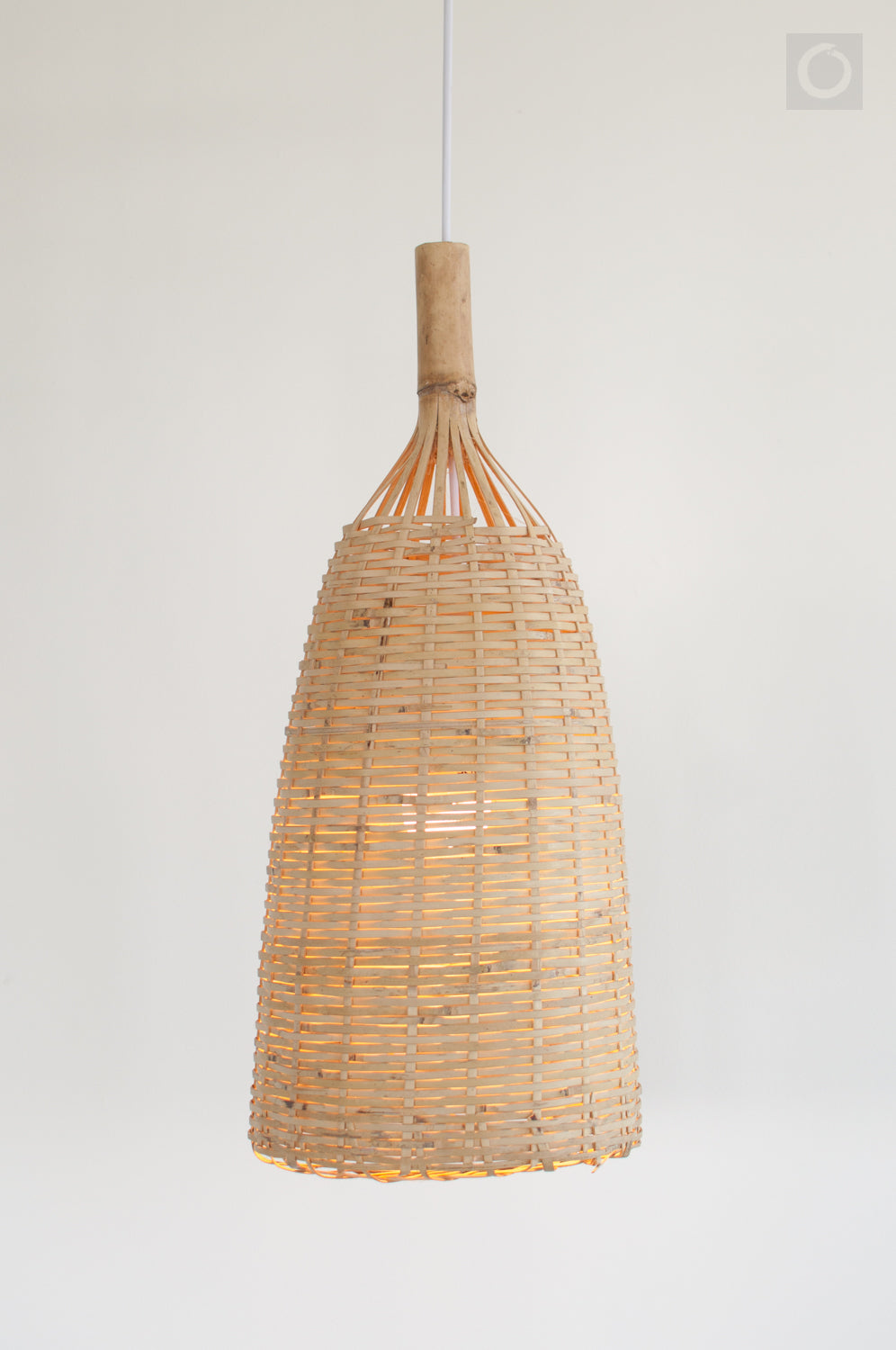 Rustic woven bamboo pendant light on a plain background