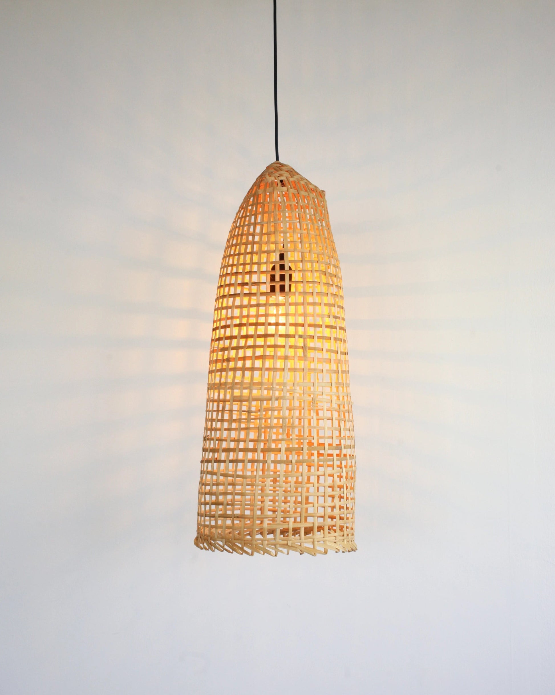 Wabi-Sabi Rustic bamboo pendant light on a plain background