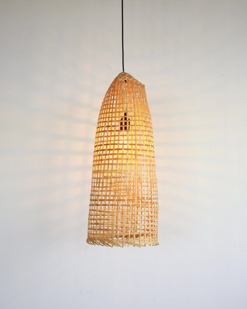 Wabi-Sabi Rustic bamboo pendant light on a plain background