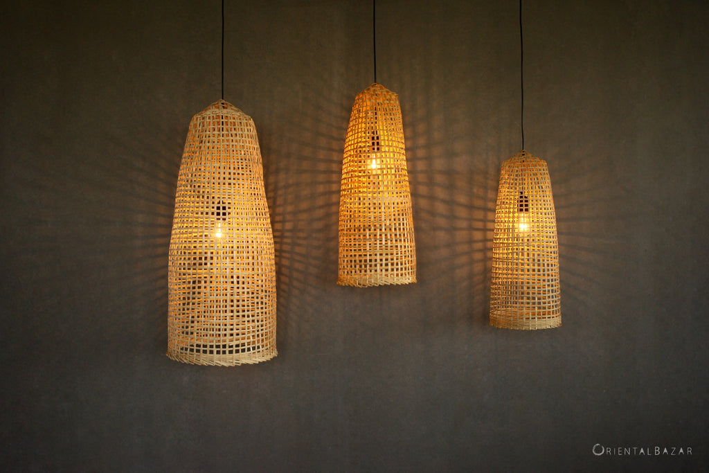 Three wabi-sabi bamboo pendant lights on a dark background