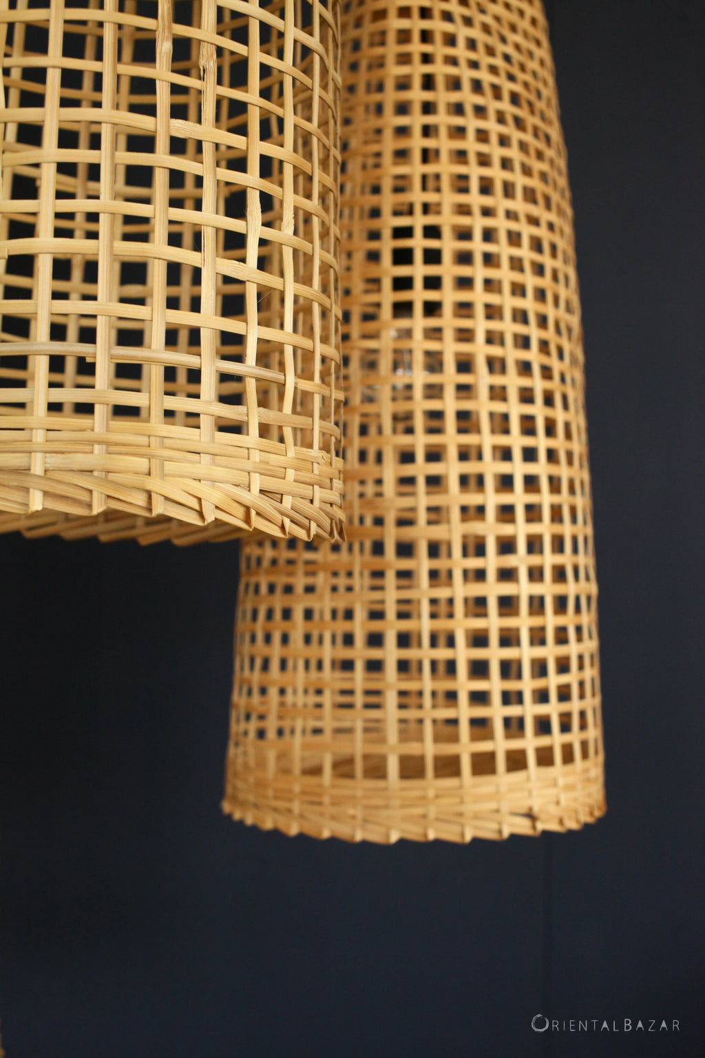 Close-up of a woven rattan lampshade against a dark background