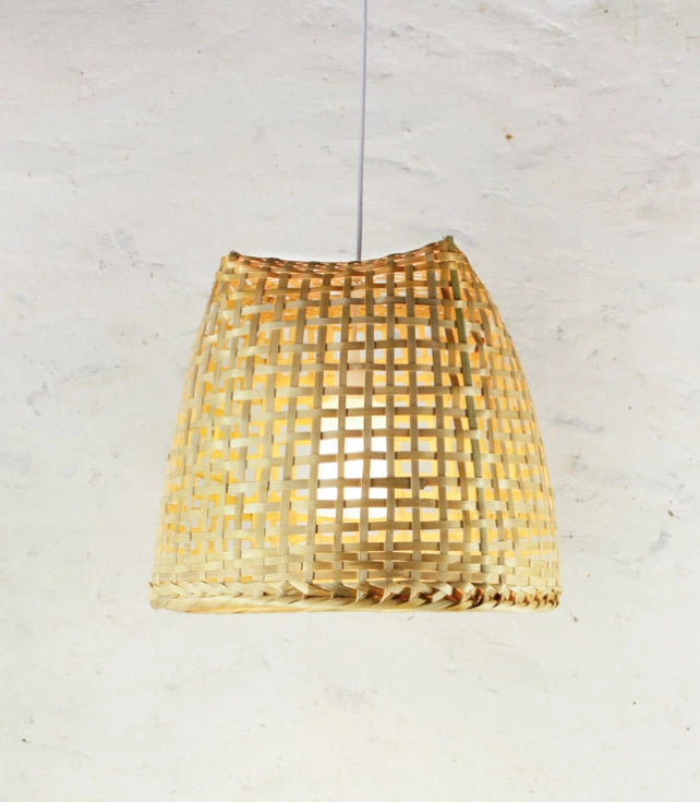 Woven bamboo basket lampshade on a white background