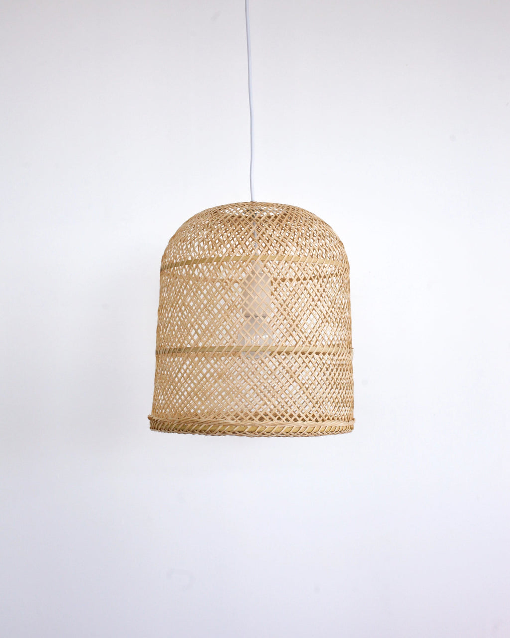 Woven rattan bamboo pendant light on a white background