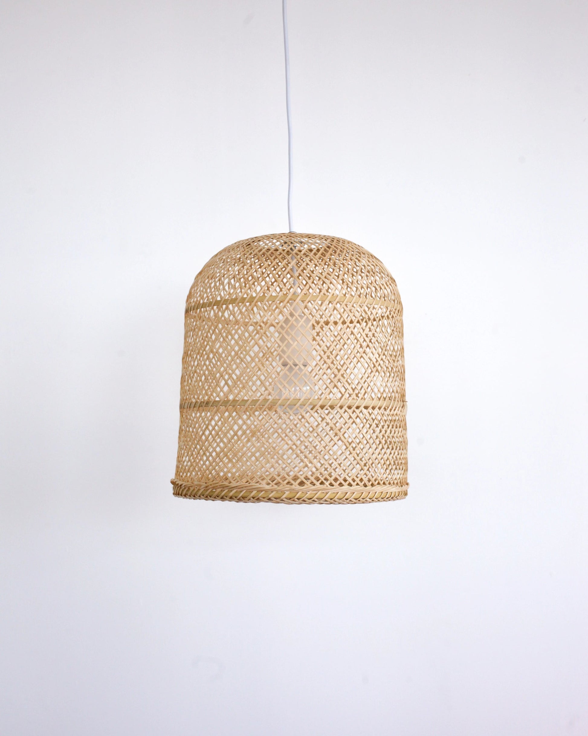 Woven rattan bamboo pendant light on a white background
