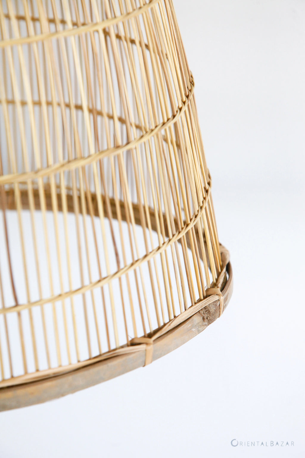 Close-up of a wicker bamboo lamp on a white background